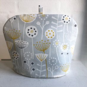 Tehtte , tevarmer i lys gr bomuldsstof med abstrakte blomster .