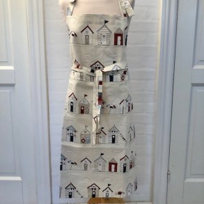 Forklde i bomuld med lys bund og motiver af farvestrlende badehuse.