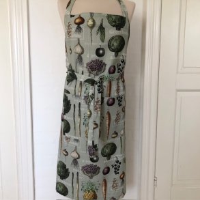 Forklde i lys grn bomuld med grntsager.