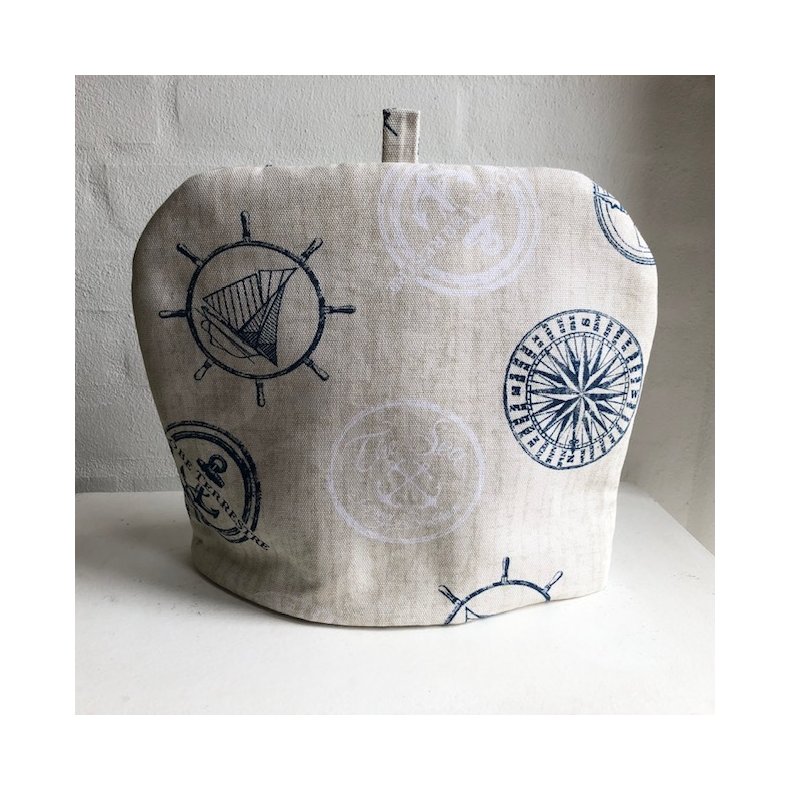 Tevarmer i beige stof med maritime motiver.