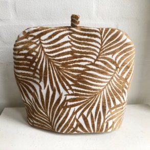 Tehtte , tevarmer i et kraftigt stof med lys bund og beige fremhvede blade.