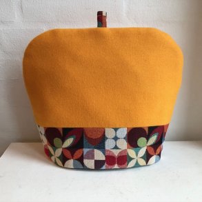 Tehtte ,tevarmer i orange / gul uld med en kant af gobelin forneden.